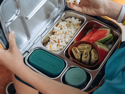 Stainless steel lunchbox with compartments containing various foods.