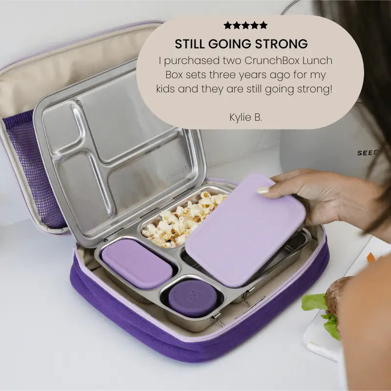 Purple and silver compartmentalized lunch box with multiple sections for food storage.