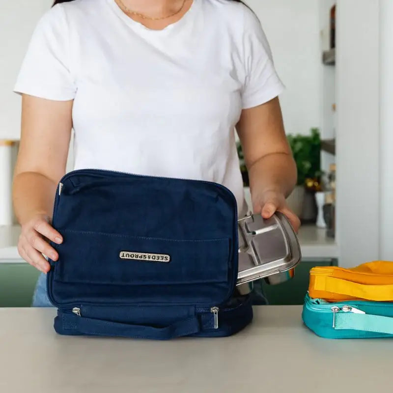 Navy blue insulated lunch bag with multiple compartments and a gold-colored logo.