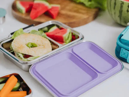Stainless steel lunch container with a purple plastic lid.
