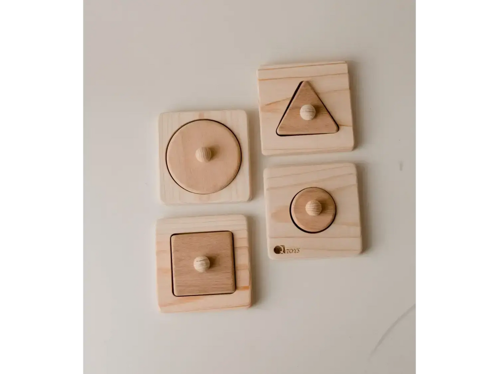 Set of wooden shape puzzles with circular, triangular, and square pieces.