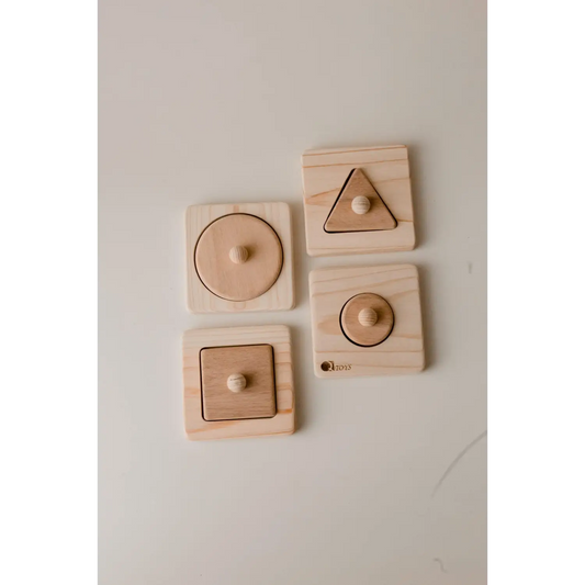 Set of wooden shape puzzles with circular, triangular, and square pieces.
