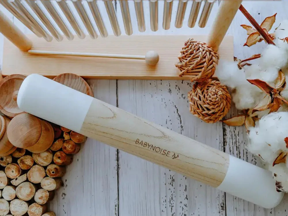 Wooden rolling pin with white marble barrel.