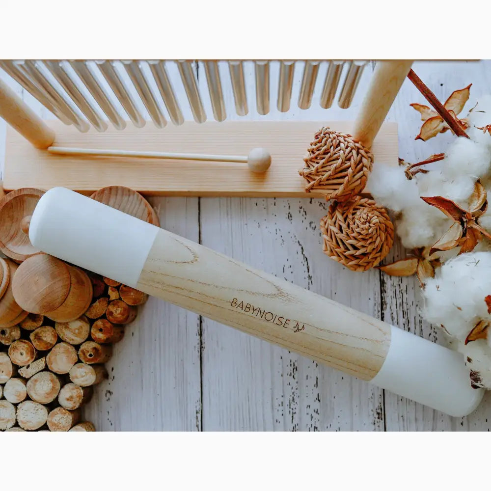 Wooden rolling pin with white marble barrel.