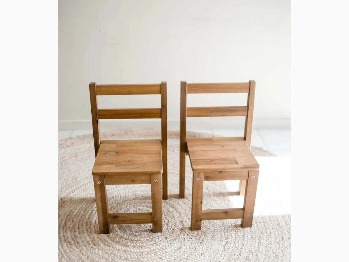Two wooden children’s chairs.