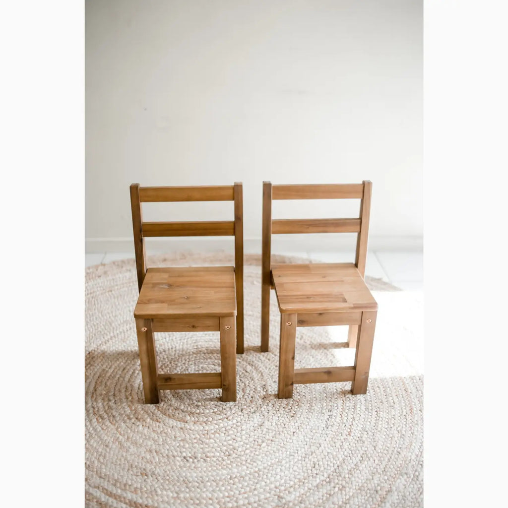 Two wooden children’s chairs.