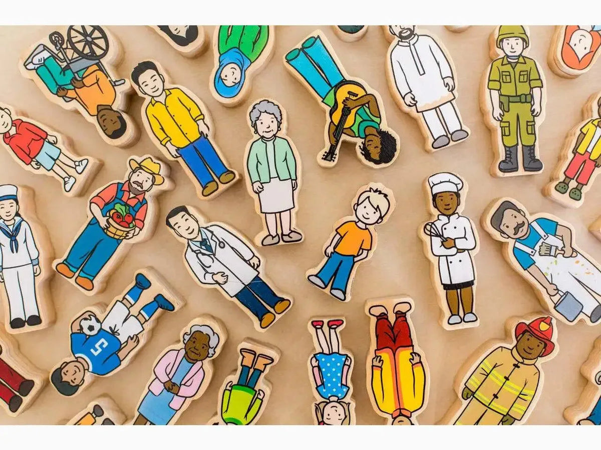 The Freckled Frog wooden village people figures laid out on a wooden table