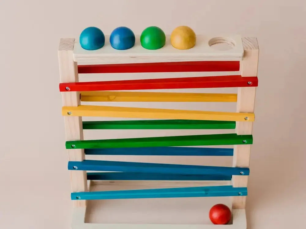 Wooden toy with colorful balls and sliding bars.