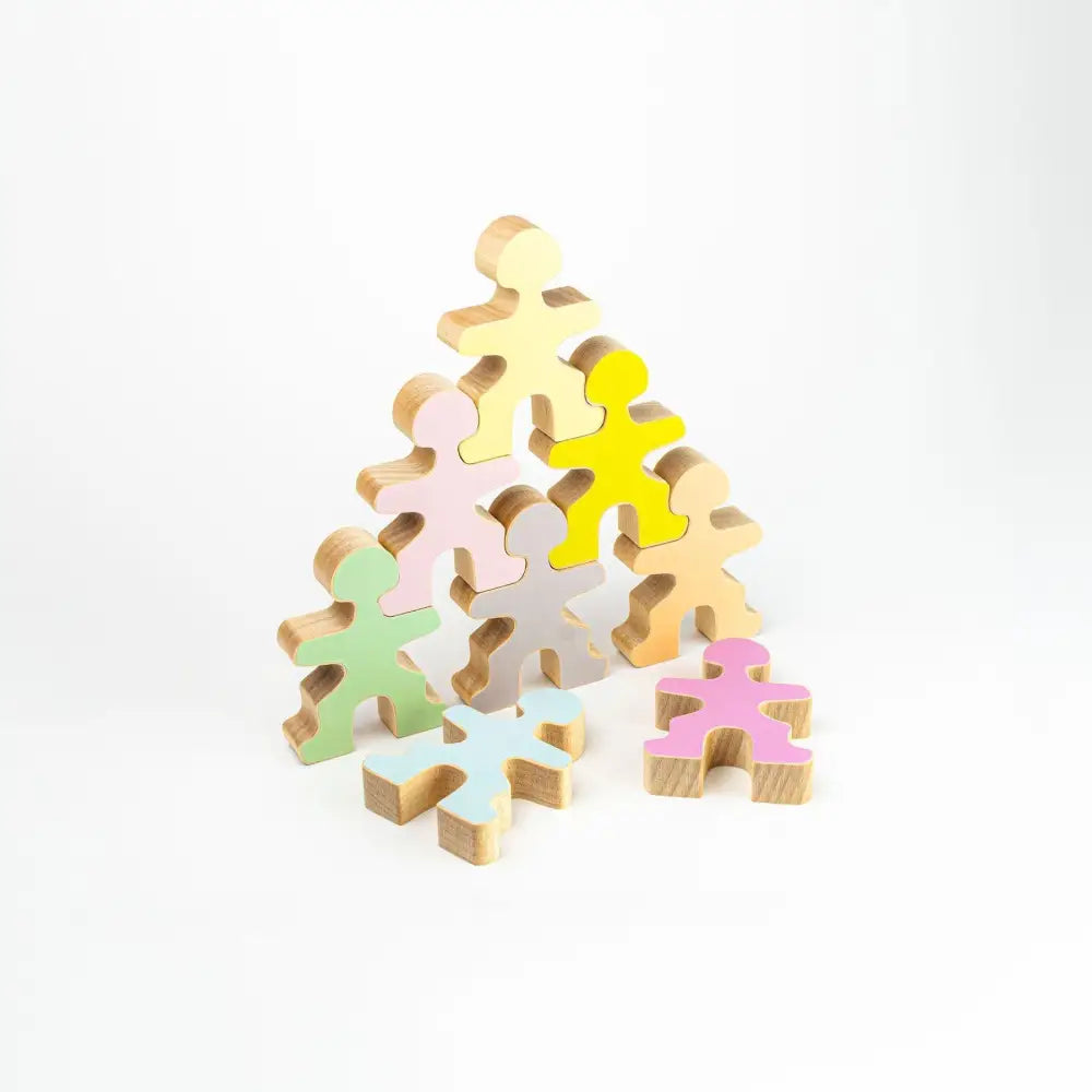 Pyramid-shaped stack of colorful wooden human figure cutouts.