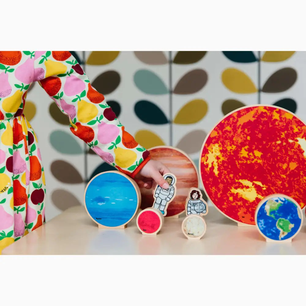 Colorful collection of planet and space-themed objects arranged on a surface.