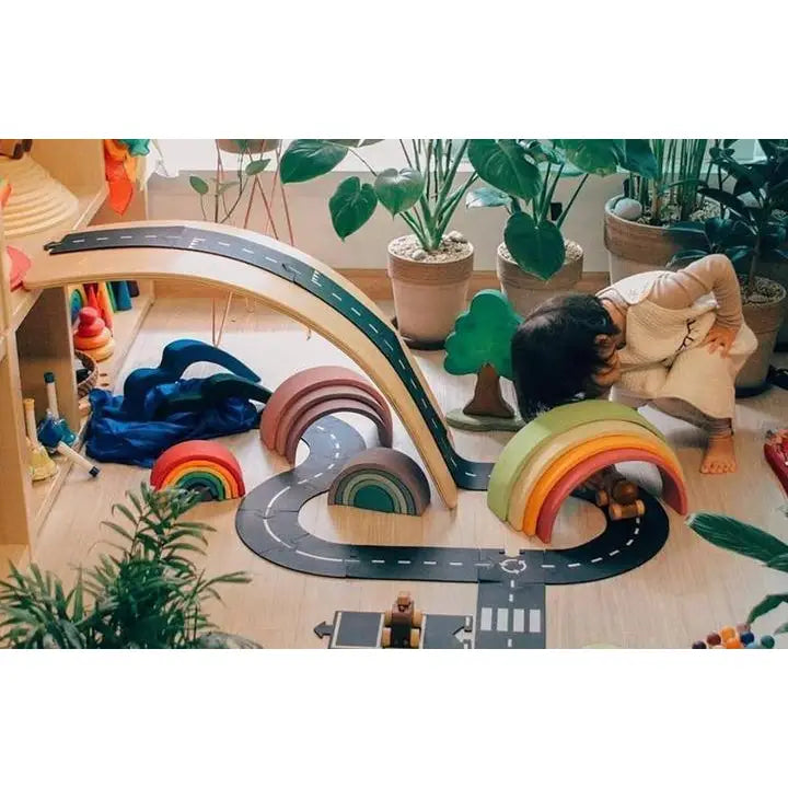 Colorful wooden rainbow-shaped stacking toy with multiple arches.