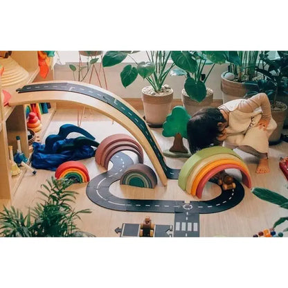 Colorful wooden rainbow-shaped stacking toy with multiple arches.