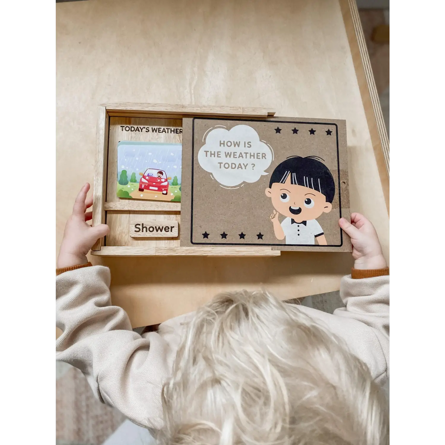 Weather and mood board for children with sliding panels and cartoon illustrations.