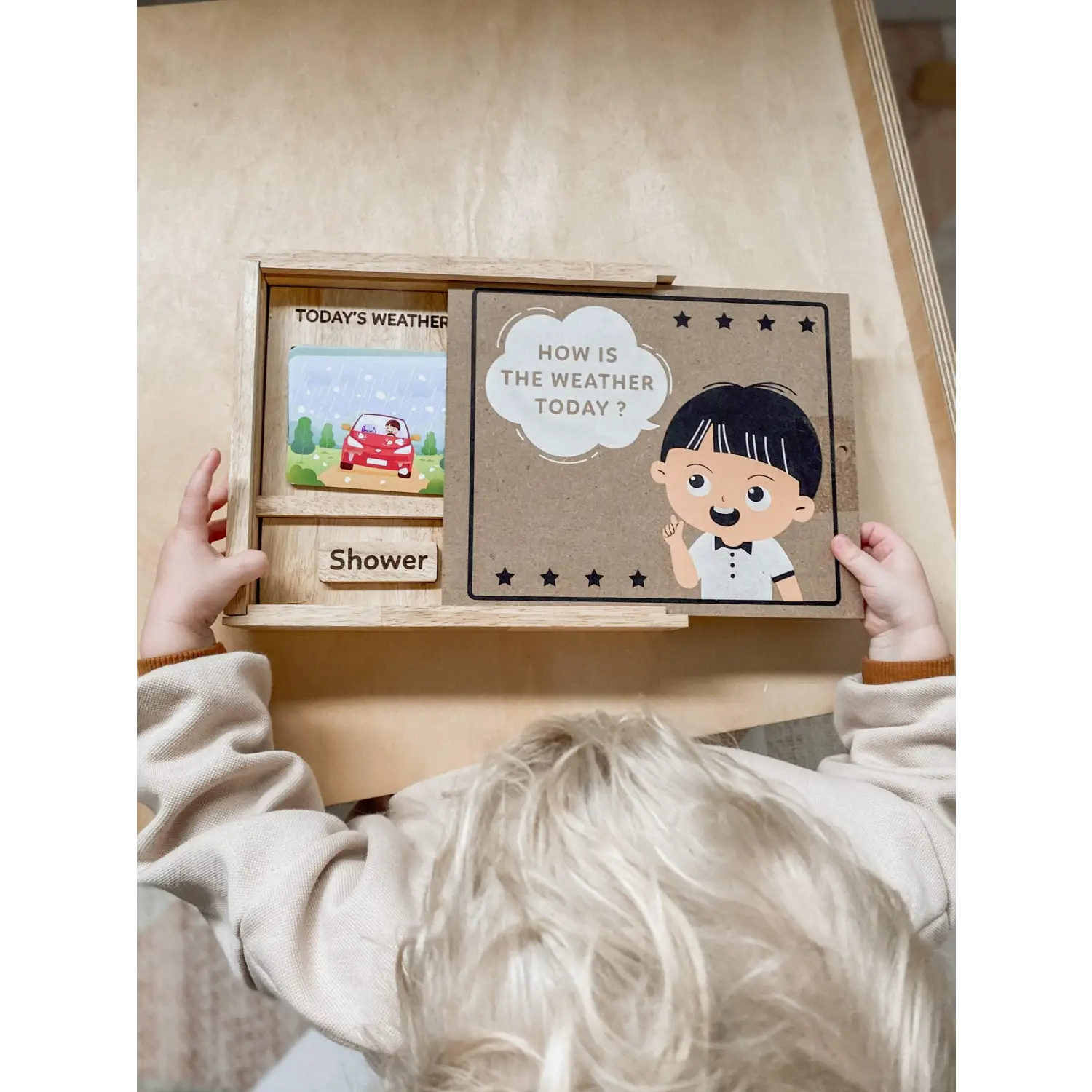 Weather and mood board for children with sliding panels and cartoon illustrations.