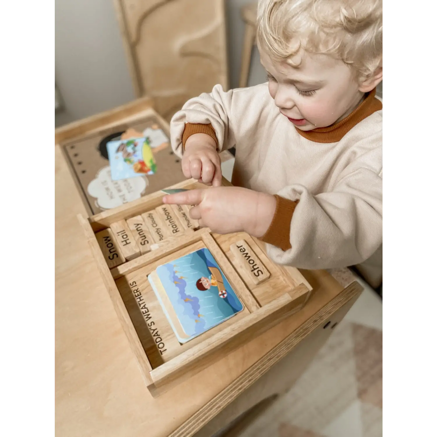 Wooden educational toy box with various compartments and learning materials.