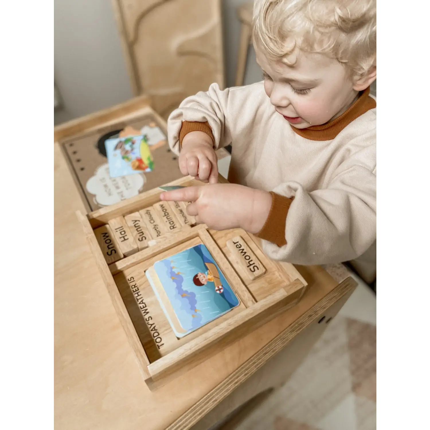 Wooden educational toy box with various compartments and learning materials.