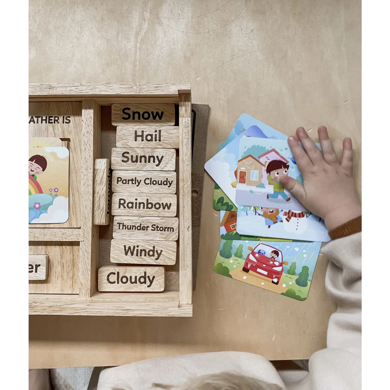 Wooden weather board with interchangeable weather condition labels and illustrated cards.