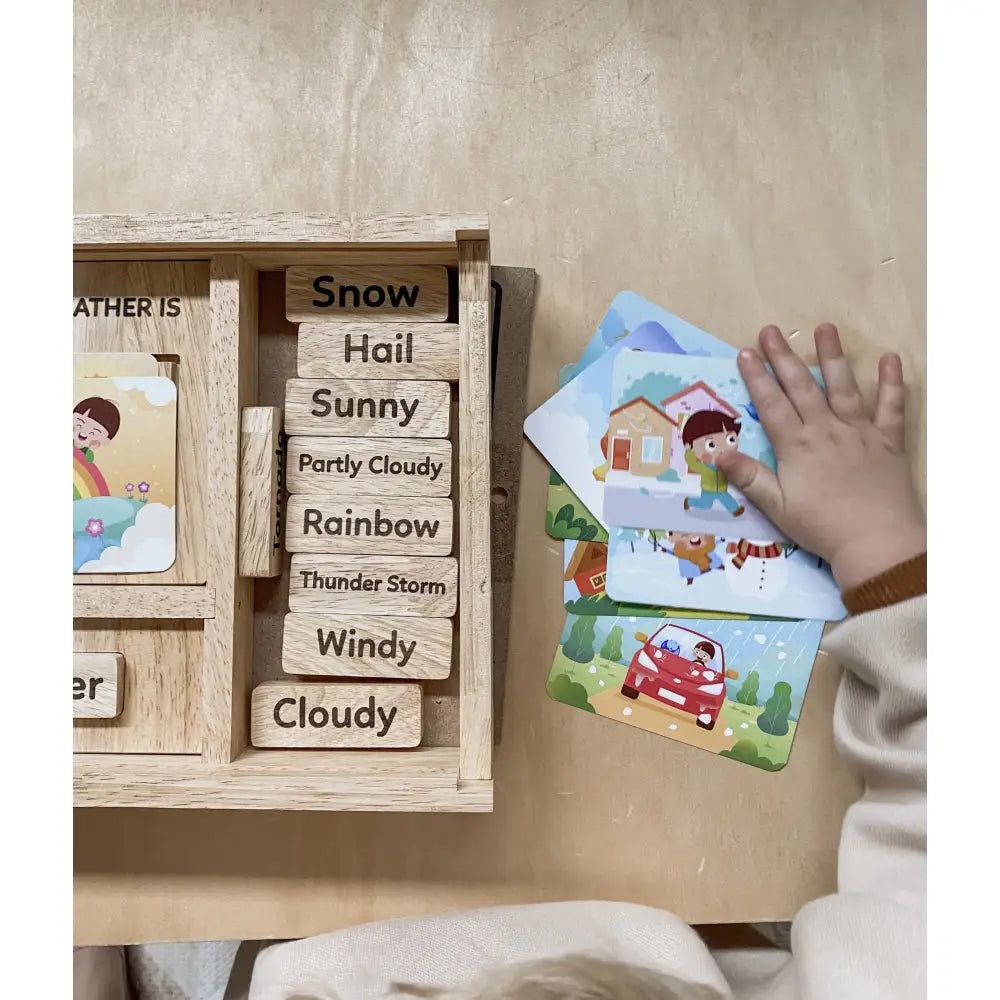 Wooden weather board with interchangeable weather condition labels and illustrated cards.