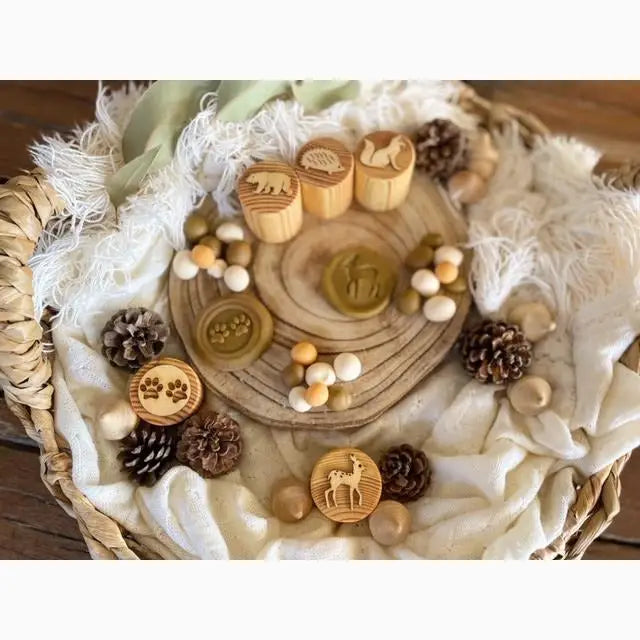 Wooden circular tray with carved designs and various decorative elements arranged on it.