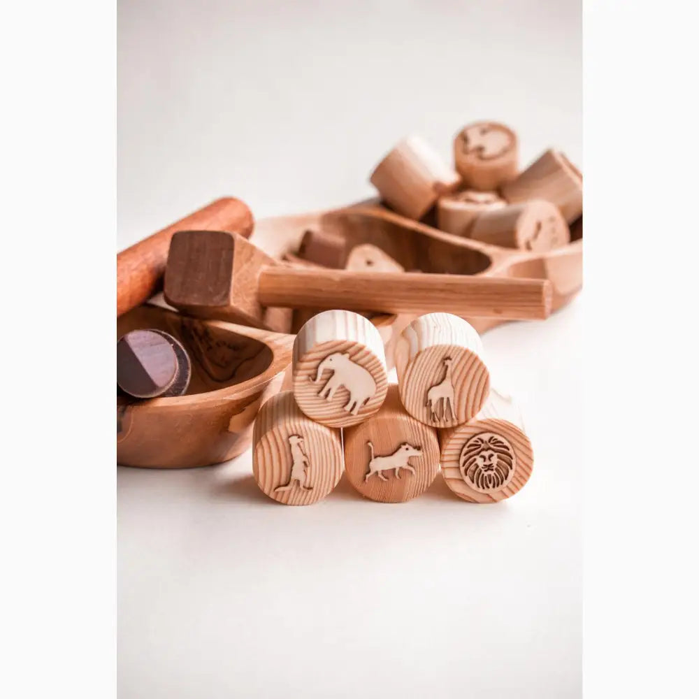 Wooden toy blocks with animal stamps or carvings on their circular faces.