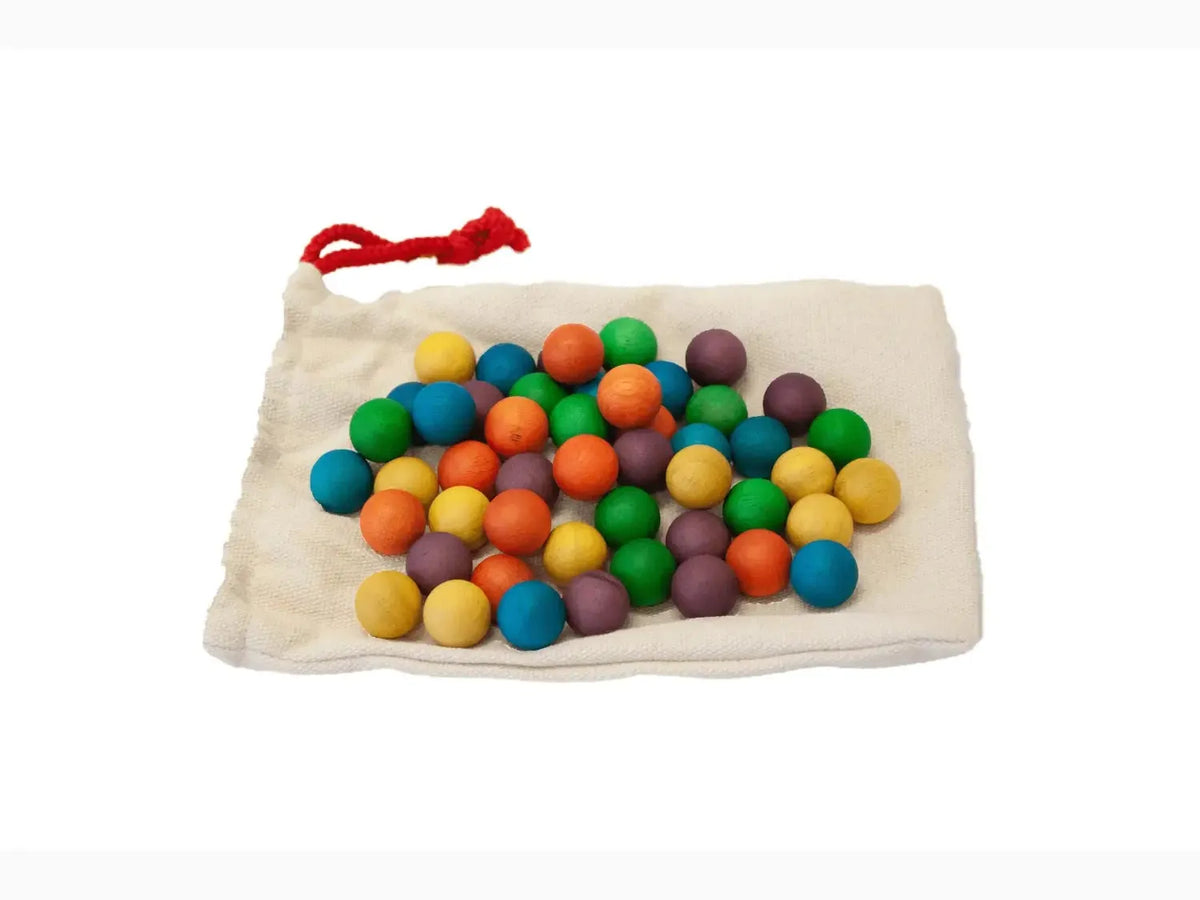Colorful wooden beads or balls in a cloth drawstring bag.
