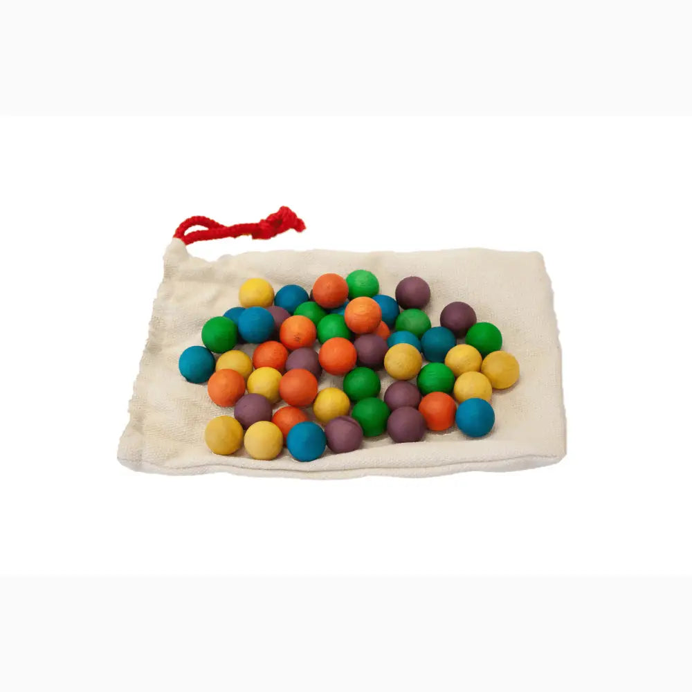 Colorful wooden beads or balls in a cloth drawstring bag.