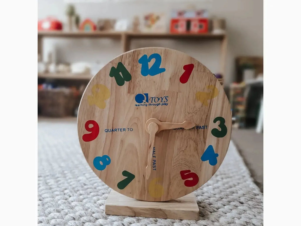Wooden toy clock with colorful numbers.