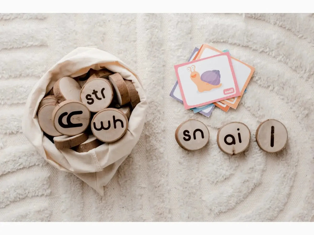 Wooden discs with letters and phonetic sounds printed on them, some in a cloth bag and others arranged separately.