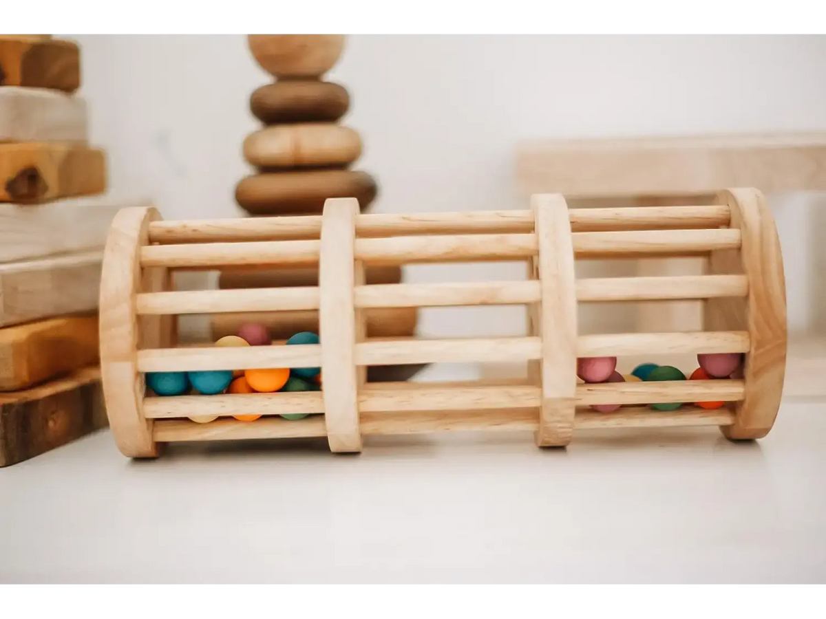 Wooden cylindrical toy with colorful beads trapped between slats.