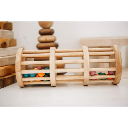 Wooden cylindrical toy with colorful beads trapped between slats.