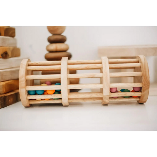 Wooden cylindrical toy with colorful beads trapped between slats.