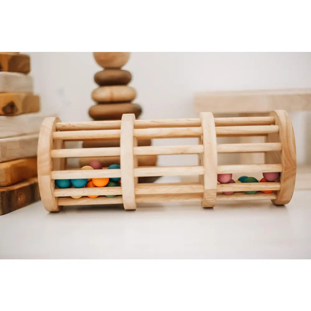 Wooden cylindrical toy with colorful beads trapped between slats.