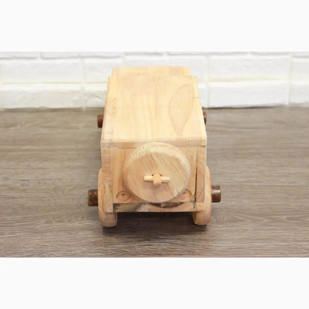 Wooden toy truck with a circular detail on its rear.